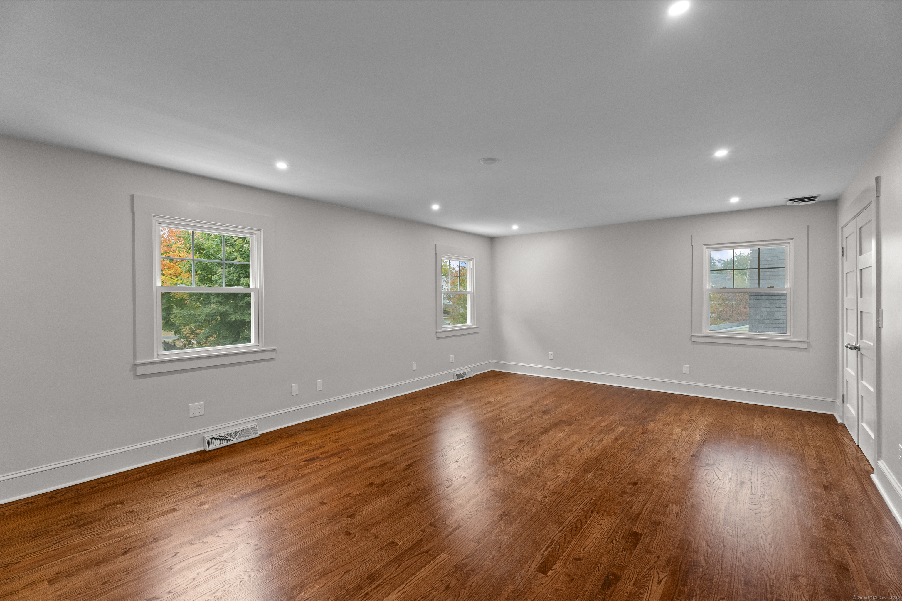 119 Westwood Road New Haven, CT 06515 - Photo 23 of 40 a view of an empty room with wooden floor and a window