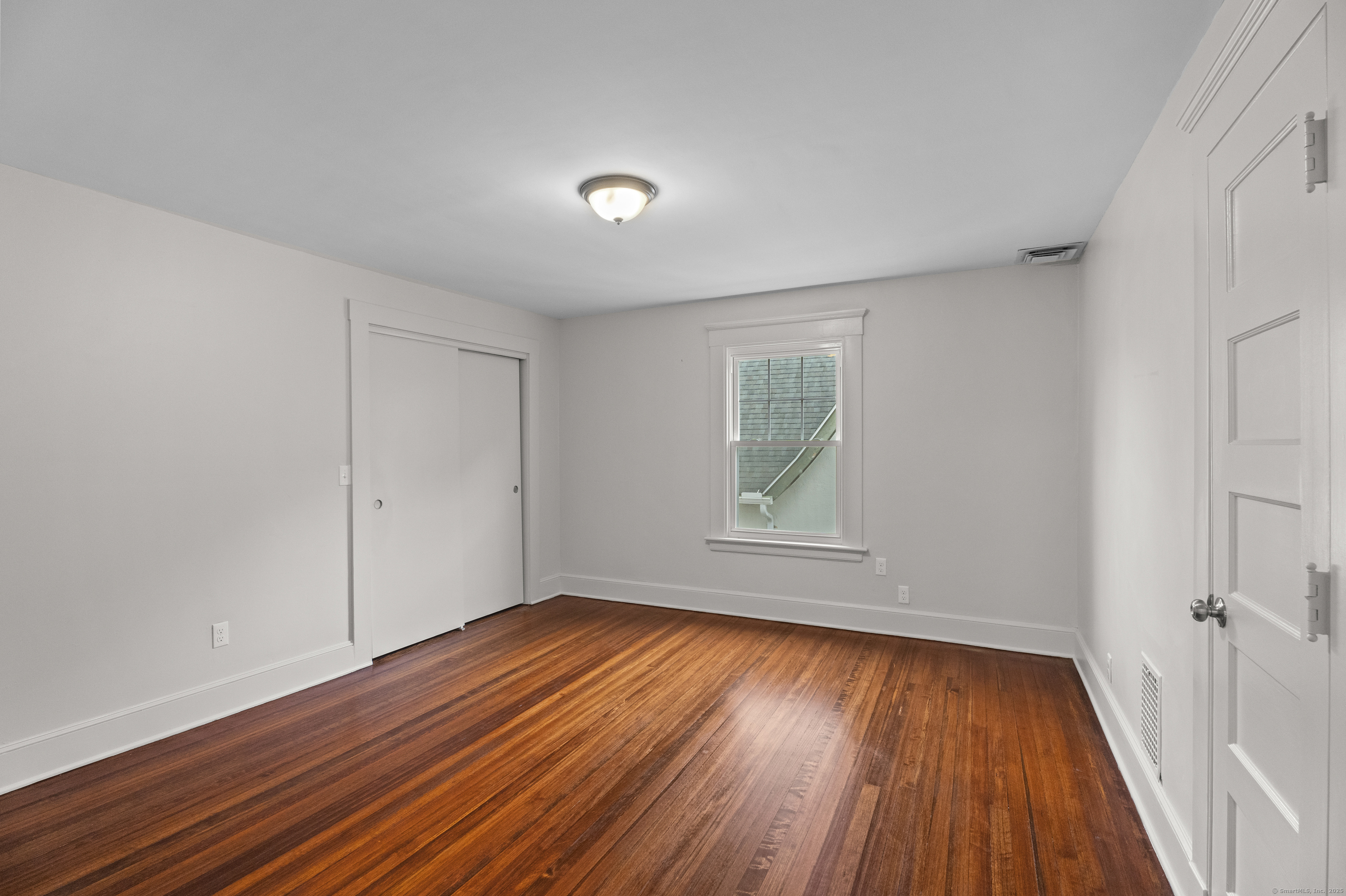 119 Westwood Road New Haven, CT 06515 - Photo 28 of 40 a view of empty room with wooden floor and fan