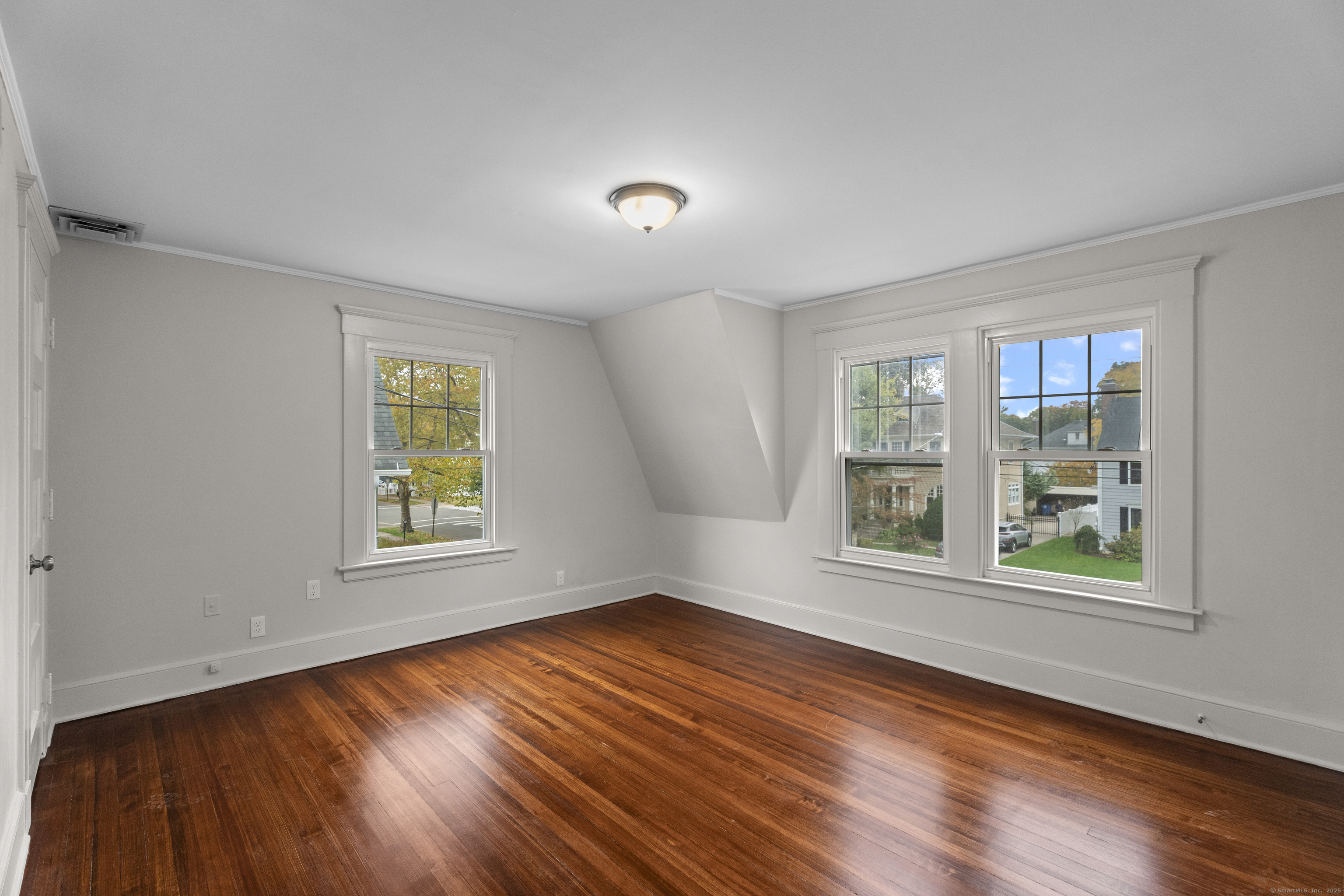 119 Westwood Road New Haven, CT 06515 - Photo 31 of 40 an empty room with wooden floor and windows