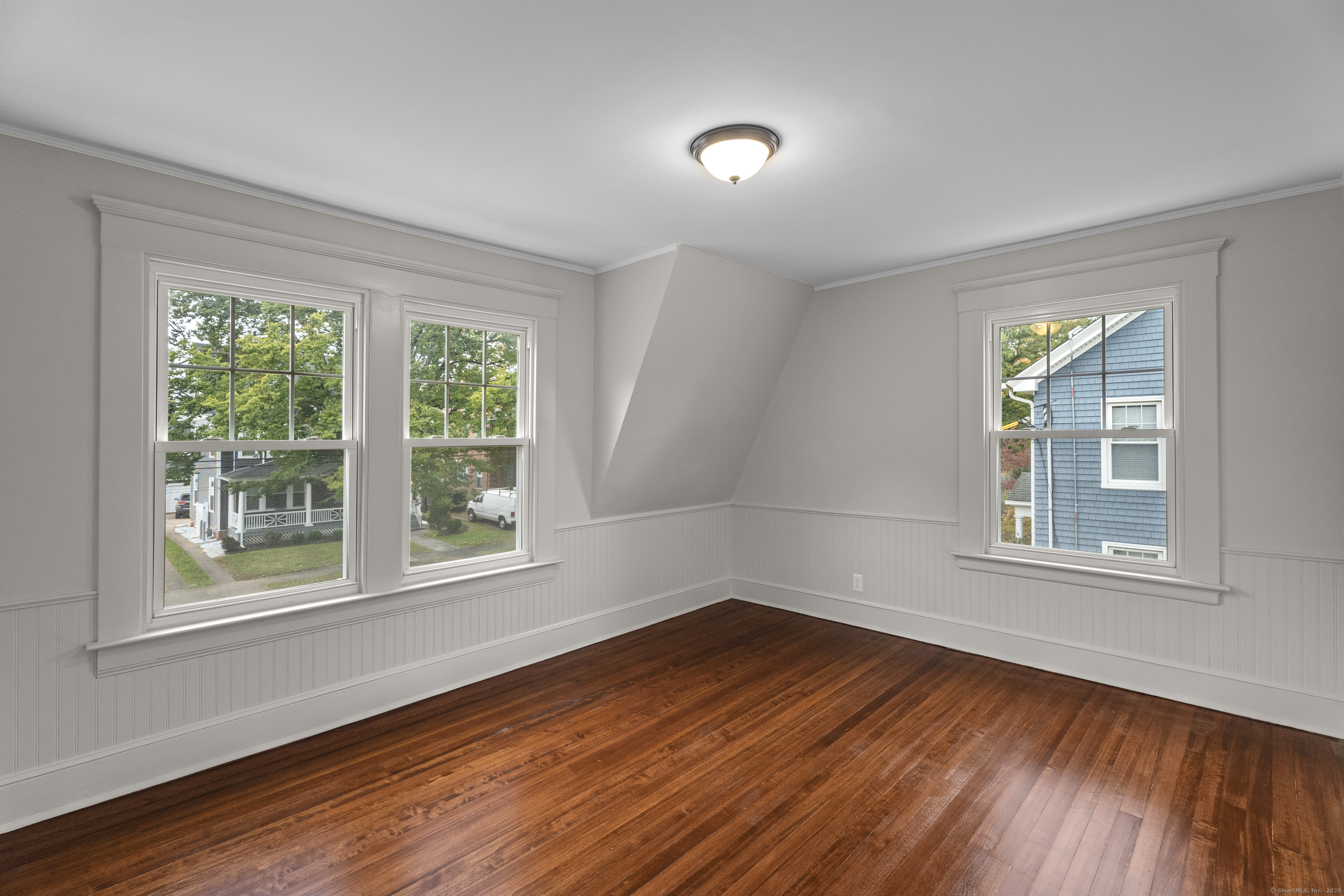 119 Westwood Road New Haven, CT 06515 - Photo 32 of 40 an empty room with wooden floor and windows