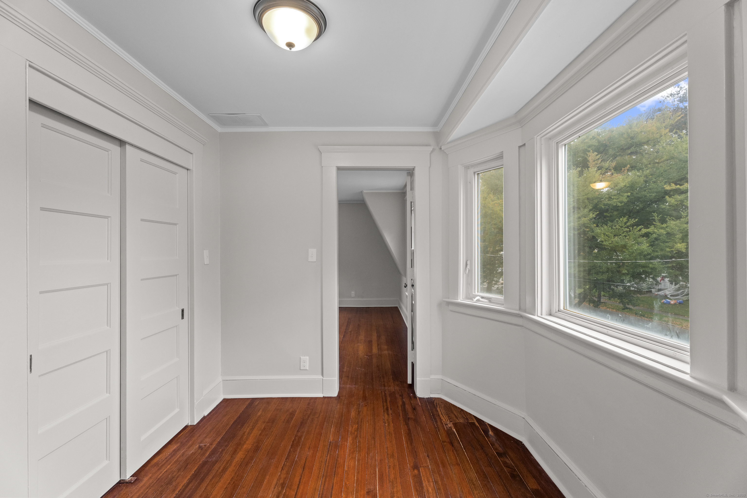 119 Westwood Road New Haven, CT 06515 - Photo 34 of 40 a view of a room with wooden floor and a window