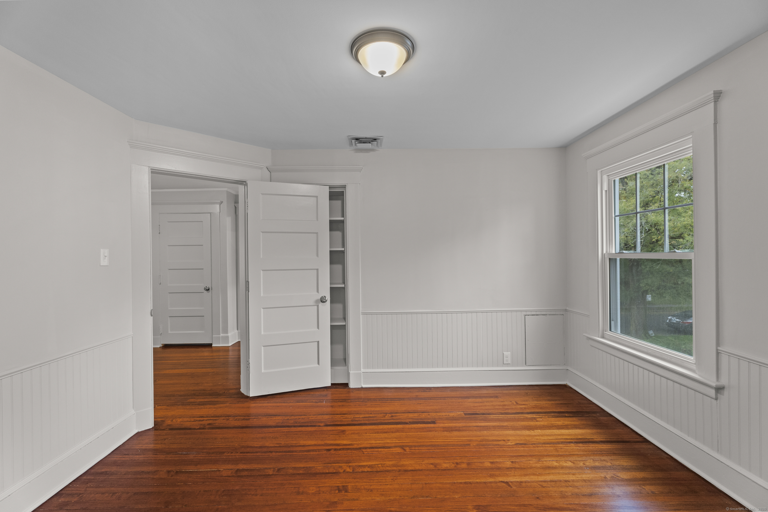 119 Westwood Road New Haven, CT 06515 - Photo 35 of 40 a view of empty room with wooden floor and fan