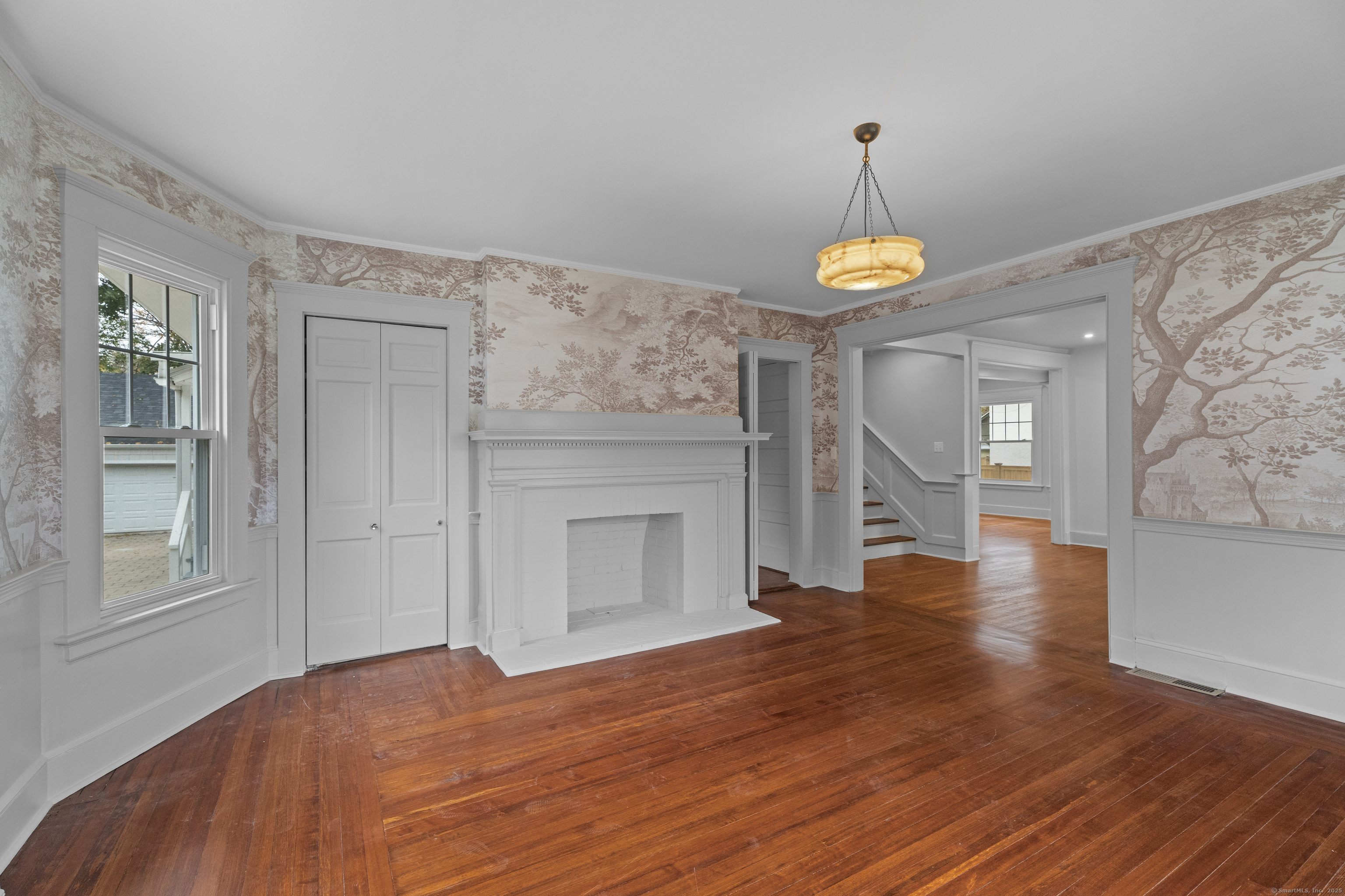 119 Westwood Road New Haven, CT 06515 - Photo 4 of 40 a view of an empty room with wooden floor and a window