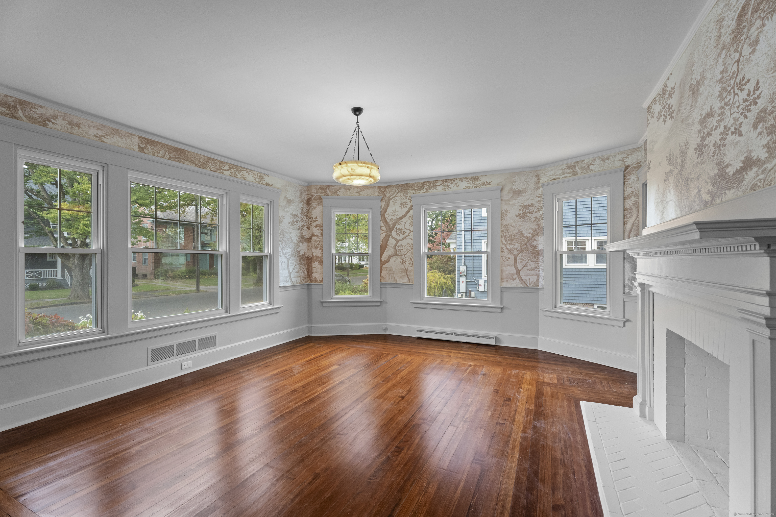 119 Westwood Road New Haven, CT 06515 - Photo 5 of 40 a view of an empty room with wooden floor and a window
