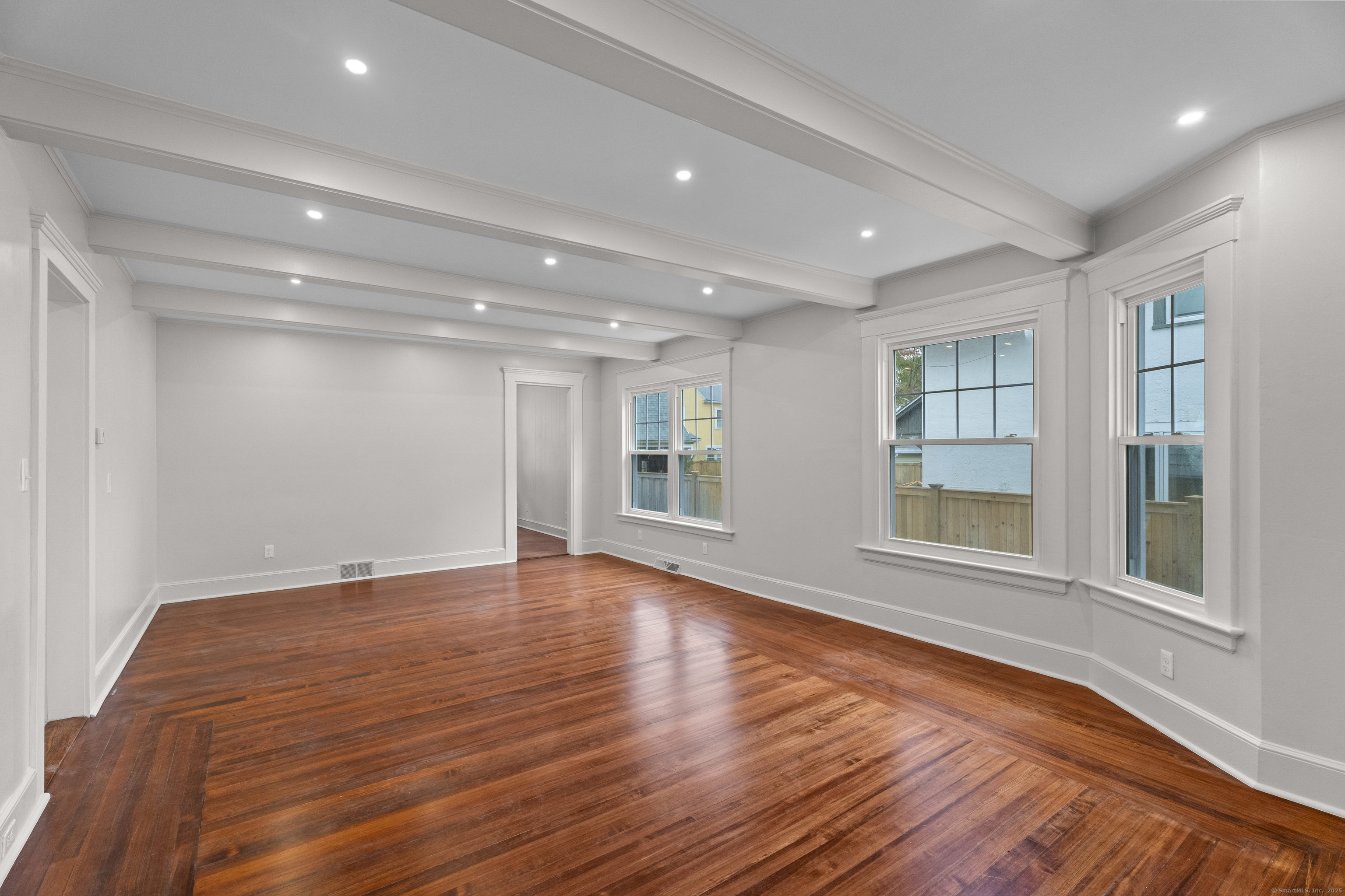 119 Westwood Road New Haven, CT 06515 - Photo 7 of 40 a view of an empty room with wooden floor and a window