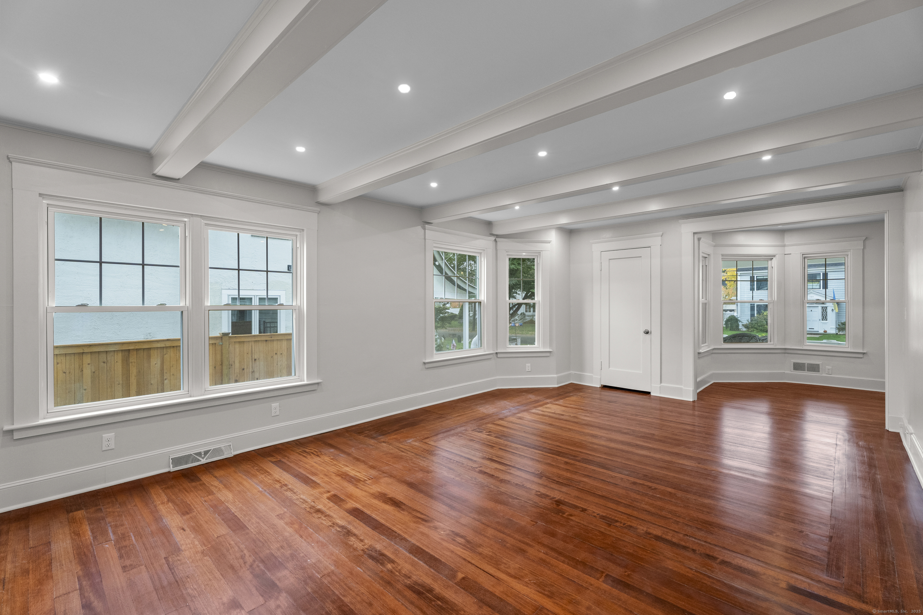 119 Westwood Road New Haven, CT 06515 - Photo 8 of 40 an empty room with wooden floor and windows