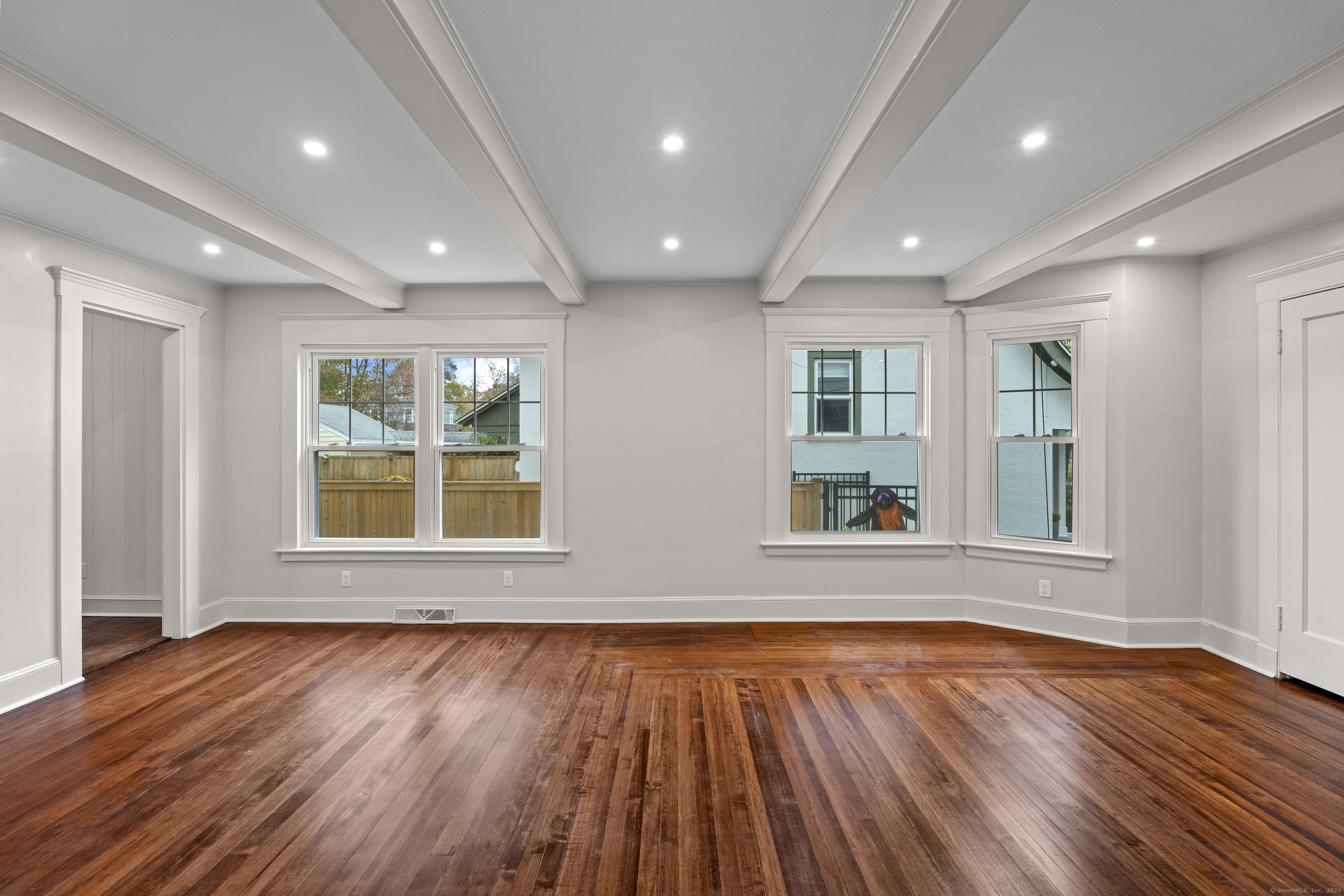 119 Westwood Road New Haven, CT 06515 - Photo 9 of 40 a view of an empty room with wooden floor and a window
