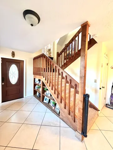 a living room with furniture and floor to ceiling windows
