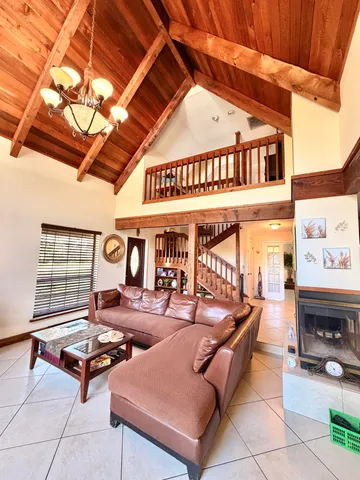 a dining room with furniture and a floor to ceiling window