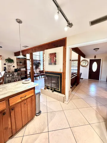 a bathroom with a granite countertop sink a toilet and mirror