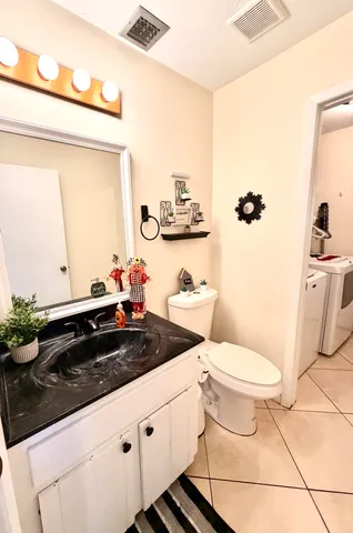 a bedroom with a bed a couch and a chandelier