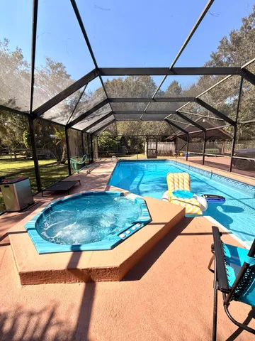 a view of a house with backyard and sitting area
