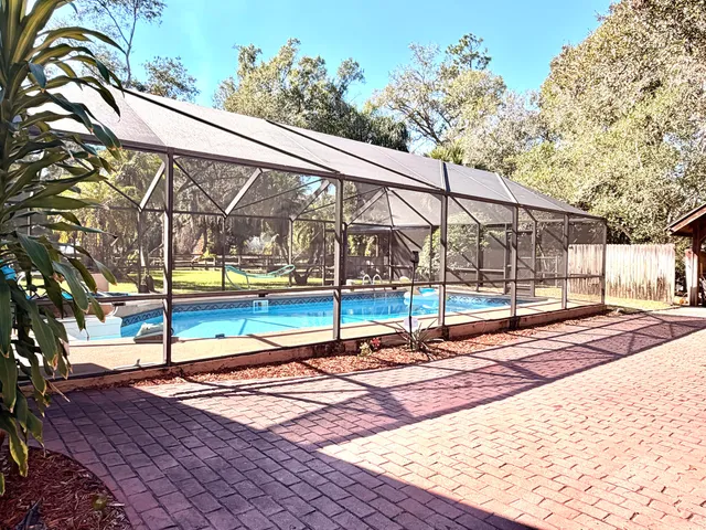 a view of a backyard with swimming pool
