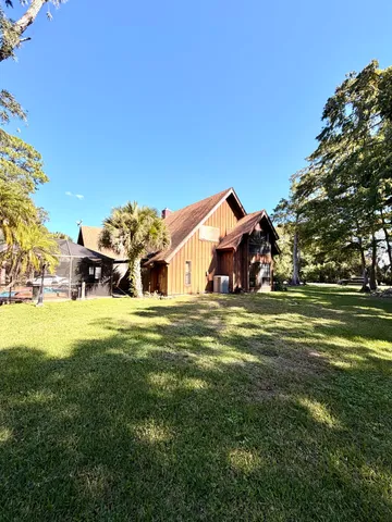 a front view of a house with a big yard