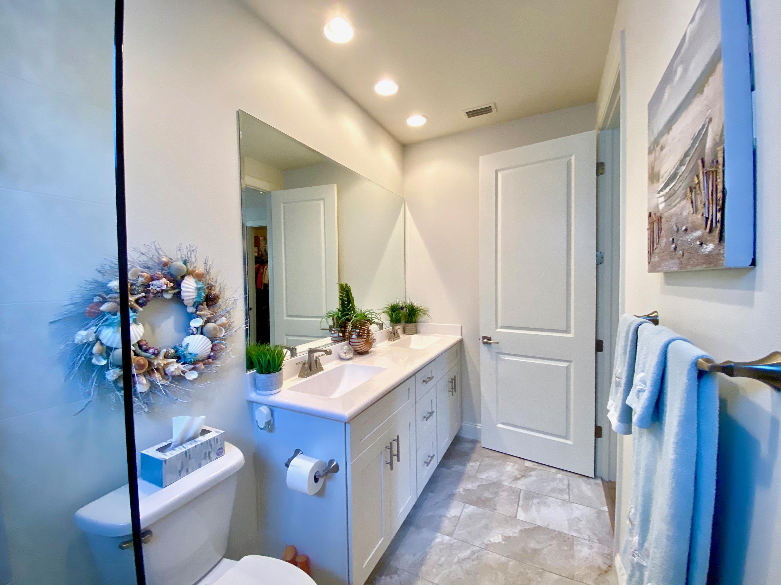 100 North Zander Way Santa Rosa Beach, FL 32459 - Photo 26 of 50 a bathroom with a sink a mirror and a toilet