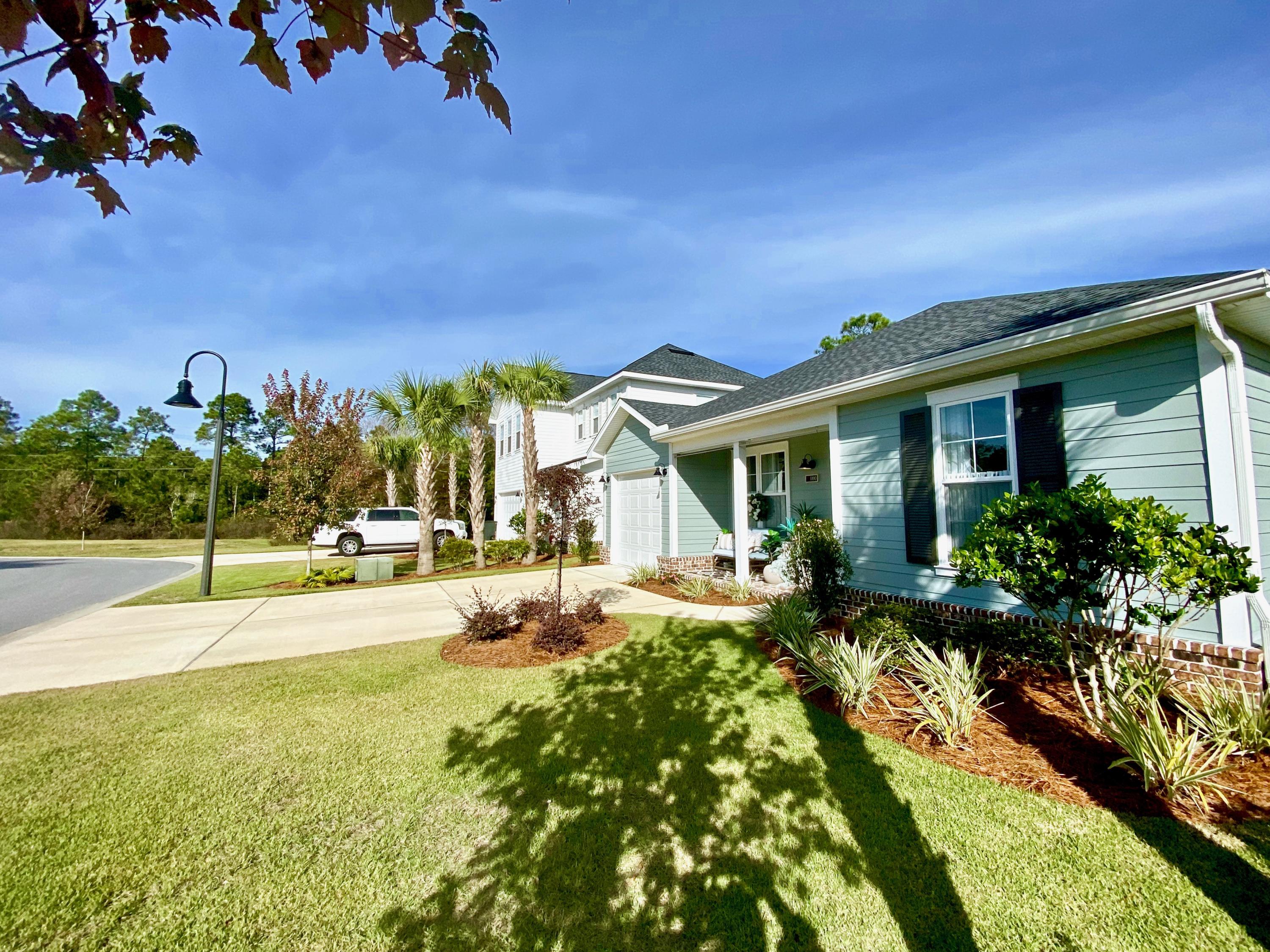 100 North Zander Way Santa Rosa Beach, FL 32459 - Photo 3 of 50 a view of a house with backyard porch and garden