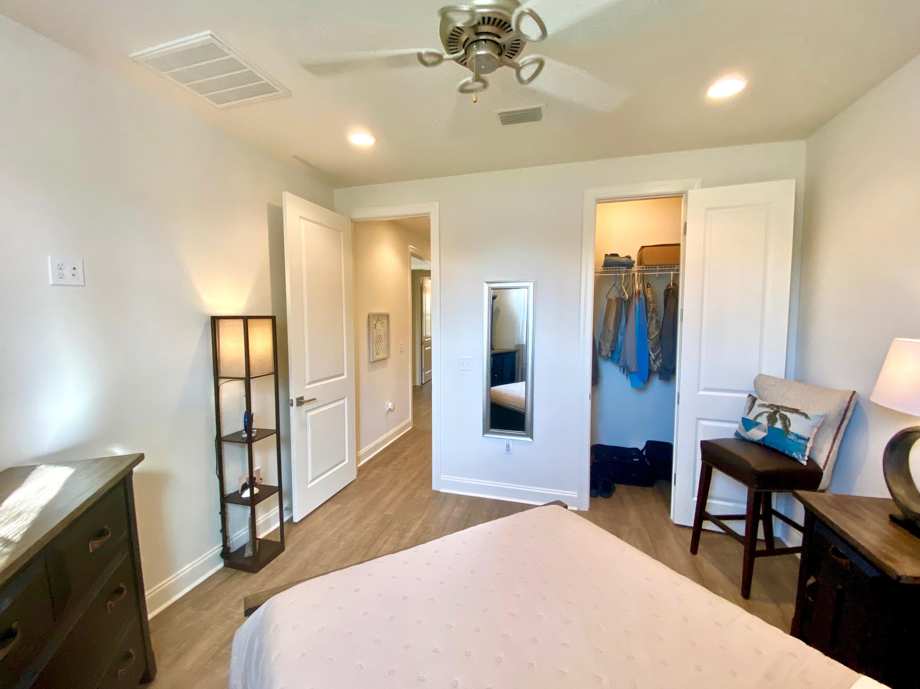 100 North Zander Way Santa Rosa Beach, FL 32459 - Photo 33 of 50 a spacious bedroom with a bed mirror and a desk