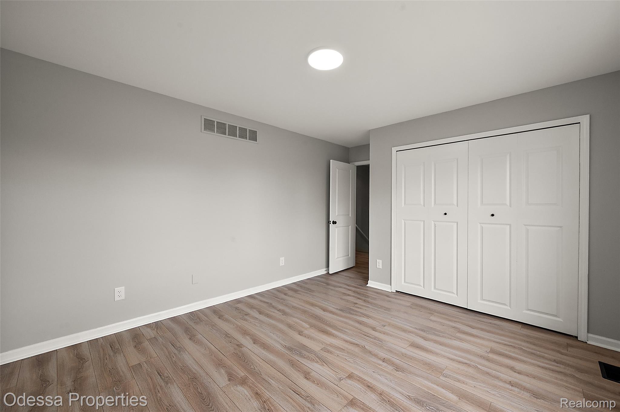 1442 Riley Center Road Memphis, MI 48041 - Photo 37 of 62 Unfurnished bedroom with light wood-style flooring and a closet