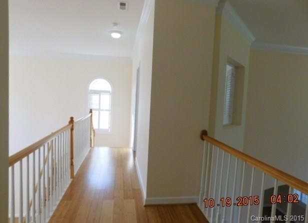 10004 Paradise Ridge Road, Unit 68 Charlotte, NC 28277 - Photo 16 of 24 a view of a hallway with wooden floor and staircase