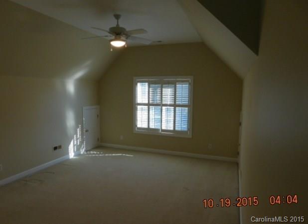 10004 Paradise Ridge Road, Unit 68 Charlotte, NC 28277 - Photo 19 of 24 en empty room with windows and fan
