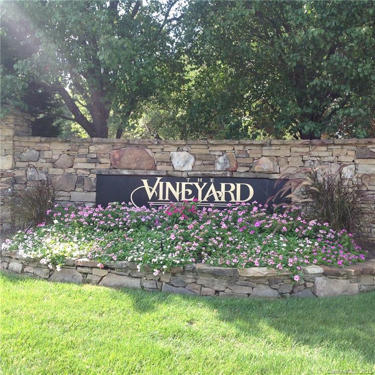 10004 Paradise Ridge Road, Unit 68 Charlotte, NC 28277 - Photo 24 of 24 a sign that is sitting in front of flowers