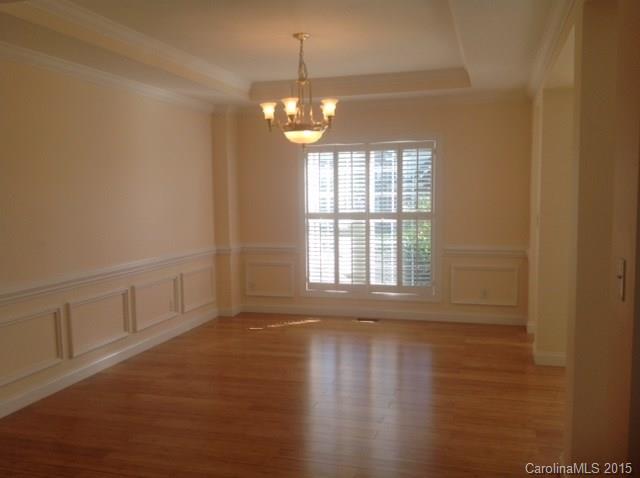 10004 Paradise Ridge Road, Unit 68 Charlotte, NC 28277 - Photo 4 of 24 a view of an empty room with wooden floor and a window