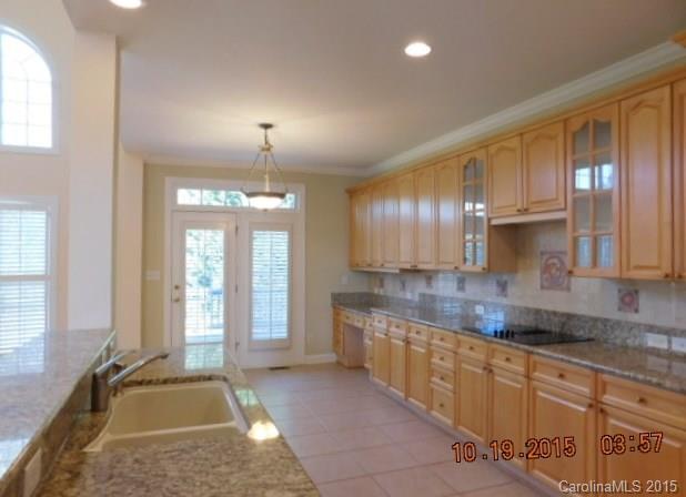 10004 Paradise Ridge Road, Unit 68 Charlotte, NC 28277 - Photo 10 of 24 a large kitchen with kitchen island granite countertop a sink and a stove
