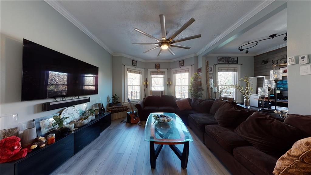 3216 Glenwood Road Brooklyn, NY 11210 - Photo 12 of 50 a living room with furniture and a flat screen tv