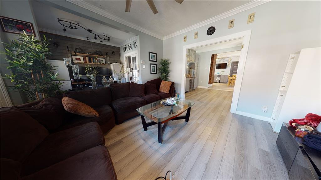 3216 Glenwood Road Brooklyn, NY 11210 - Photo 13 of 50 a living room with furniture and wooden floor