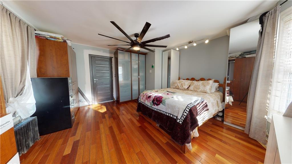 3216 Glenwood Road Brooklyn, NY 11210 - Photo 17 of 50 a bedroom with a bed dresser and a large window