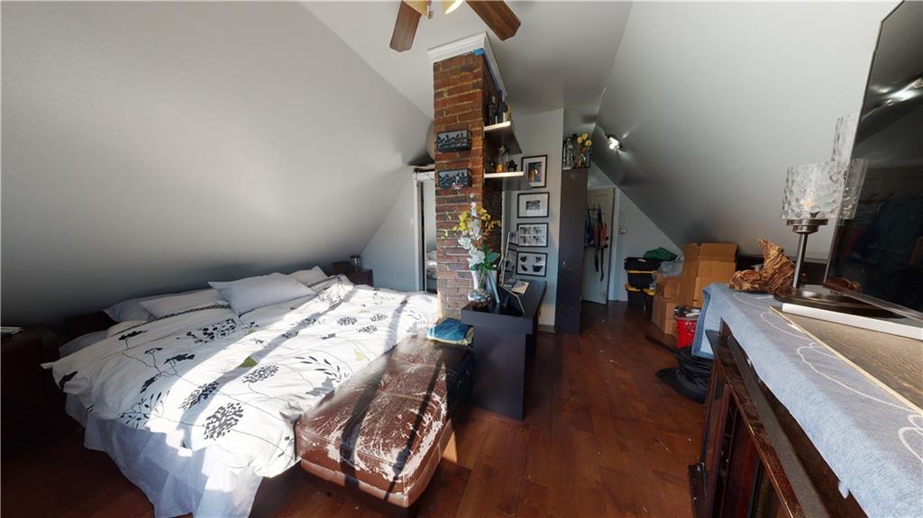 3216 Glenwood Road Brooklyn, NY 11210 - Photo 18 of 50 a bed sitting in a bedroom next to a tv