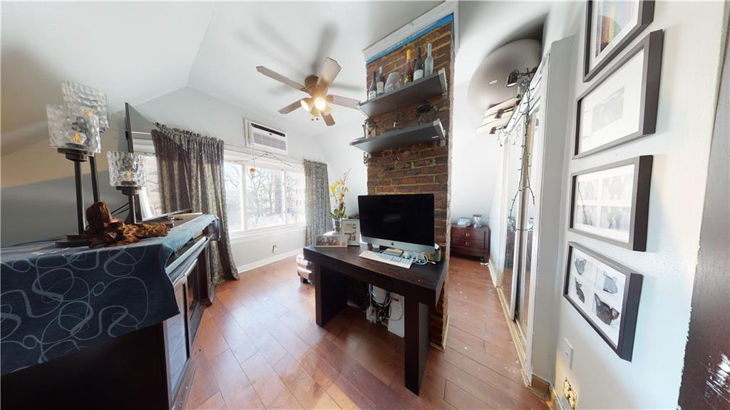 3216 Glenwood Road Brooklyn, NY 11210 - Photo 20 of 50 a view of a workspace with furniture and a flat screen tv