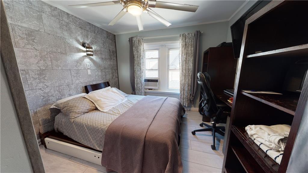 3216 Glenwood Road Brooklyn, NY 11210 - Photo 21 of 50 a bedroom with a bed and a mirror