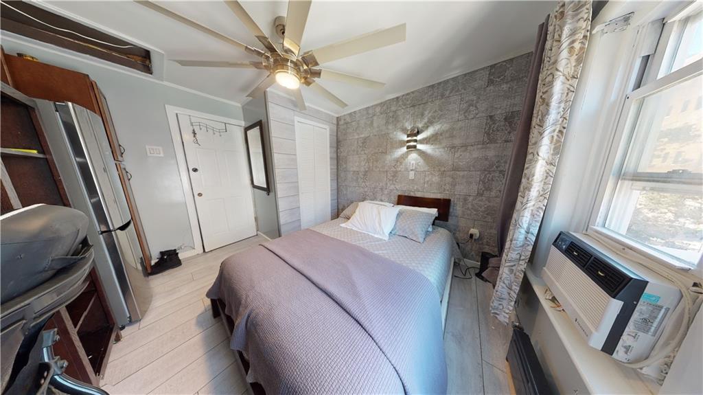 3216 Glenwood Road Brooklyn, NY 11210 - Photo 22 of 50 a bedroom with a bed and a mirror