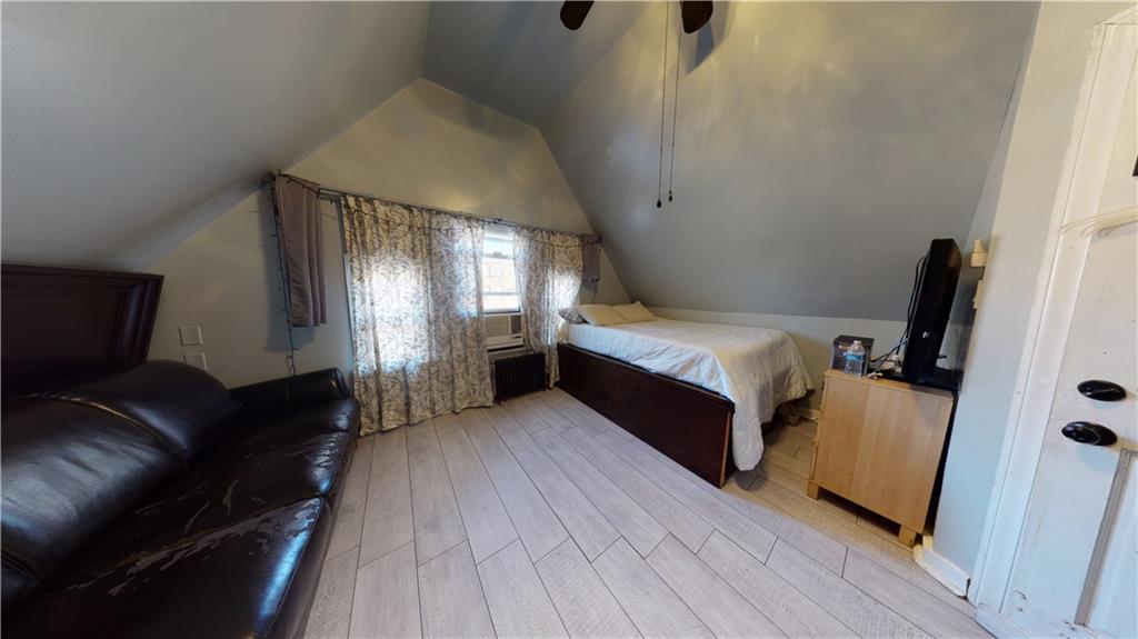 3216 Glenwood Road Brooklyn, NY 11210 - Photo 23 of 50 a spacious bedroom with a bed and wooden floor