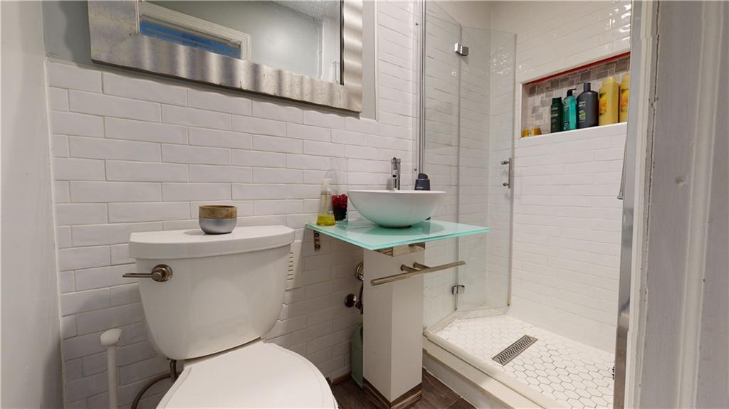 3216 Glenwood Road Brooklyn, NY 11210 - Photo 25 of 50 a white toilet sitting next to a bathroom sink