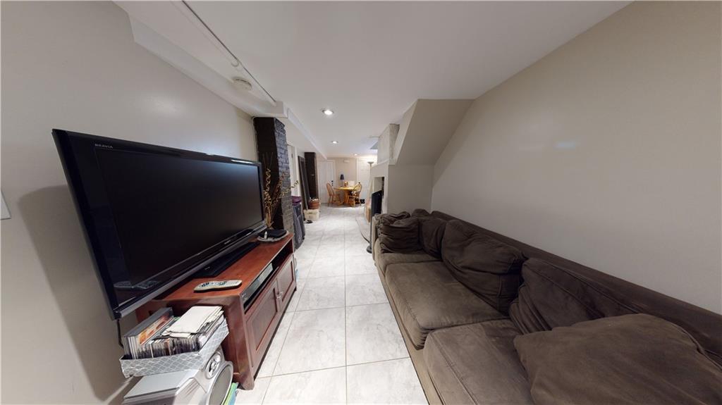 3216 Glenwood Road Brooklyn, NY 11210 - Photo 27 of 50 a living room with furniture and a flat screen tv