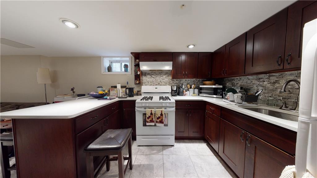 3216 Glenwood Road Brooklyn, NY 11210 - Photo 29 of 50 a kitchen with a sink stove and cabinets