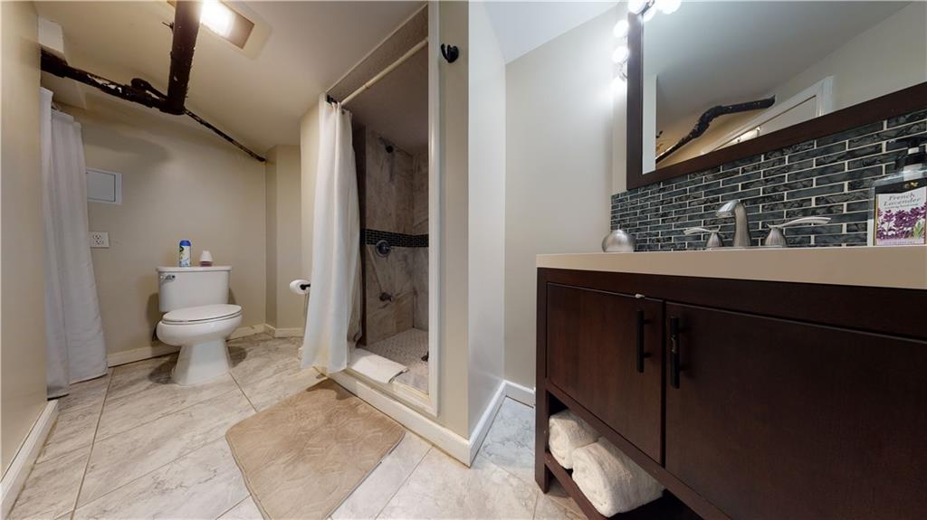 3216 Glenwood Road Brooklyn, NY 11210 - Photo 30 of 50 a bathroom with a toilet and a shower