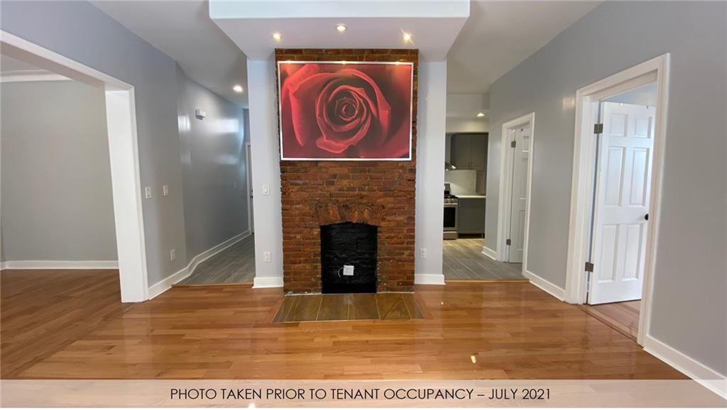 3216 Glenwood Road Brooklyn, NY 11210 - Photo 38 of 50 a view of a livingroom with fireplace and wooden floor