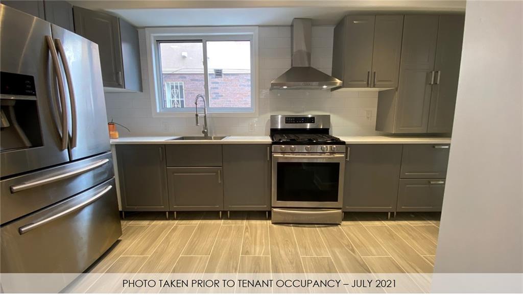 3216 Glenwood Road Brooklyn, NY 11210 - Photo 44 of 50 a kitchen with a stove and a refrigerator
