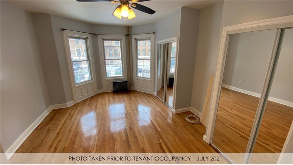 3216 Glenwood Road Brooklyn, NY 11210 - Photo 50 of 50 wooden floor in an empty room with a window