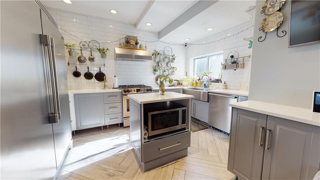3216 Glenwood Road Brooklyn, NY 11210 - Photo 6 of 50 a kitchen with stainless steel appliances a stove a sink and a refrigerator