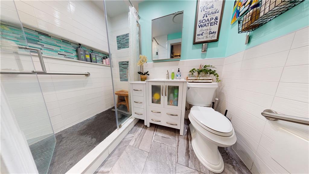 3216 Glenwood Road Brooklyn, NY 11210 - Photo 9 of 50 a bathroom with a toilet sink and mirror