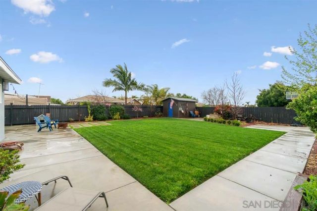 a view of a patio with a table and chairs under an umbrella