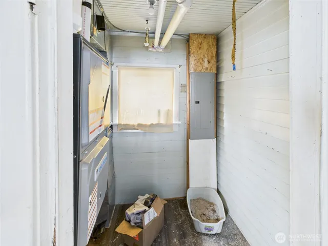 a view of a room with wooden floor and a window