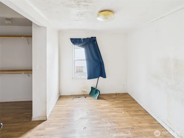 view of a room with wooden floor and white wall
