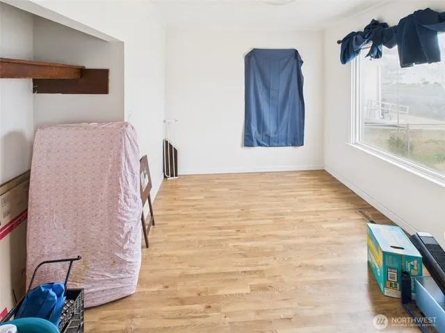 a bedroom with a bed and a painting on the wall
