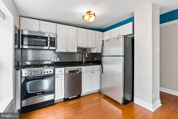 a white refrigerator freezer and a stove in a kitchen