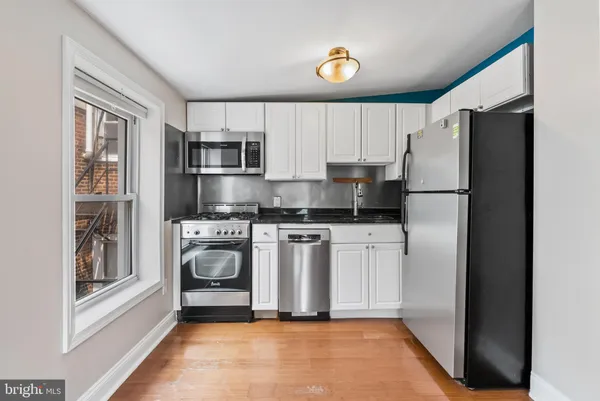 a kitchen with a refrigerator and a stove